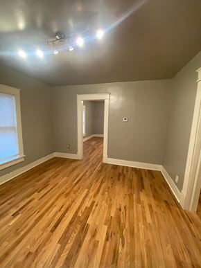 Tulsa house for rent - a living room with a hard wood floor and grey walls