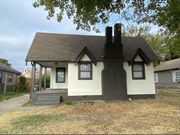 Tulsa house for rent - a small white house with a black roof and a porch