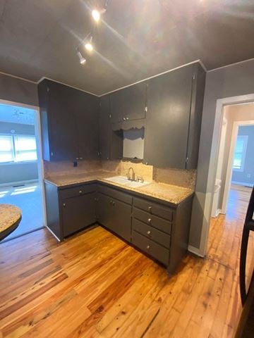 Tulsa house for rent - A kitchen with dark cabinets and a granite countertop.