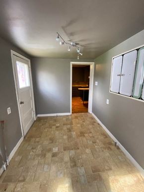 Tulsa house for rent - A room with a tiled floor and a doorway leading to another room.