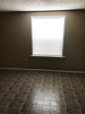 Tulsa house for rent - a room with a window and a tiled floor