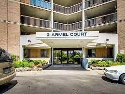 Etobicoke apartment for rent - The image shows the front of a building named 2 Armel Court with a parking lot in front.