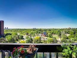 Etobicoke apartment for rent - A balcony with a view of a green landscape and buildings in the distance.