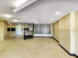 Etobicoke apartment for rent - A spacious room with a partition and a door.