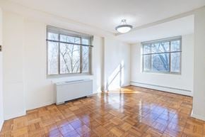 Washington apartment for rent - an empty living room with a hard wood floor and two windows