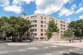 Washington apartment for rent - a large building with a statue in front of it on a city street