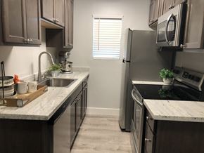Odessa apartment for rent - a kitchen with stainless steel appliances and marble counter tops