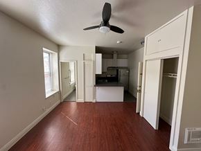 San Rafael apartment for rent - A room with a ceiling fan and wooden floors.