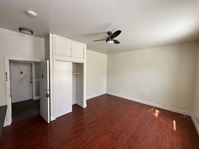 San Rafael apartment for rent - A room with a ceiling fan and a doorway leading to another room.
