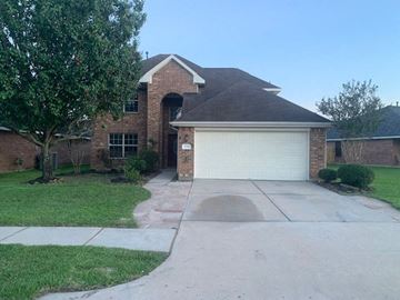 Humble house for rent - a house with a driveway and a garage door