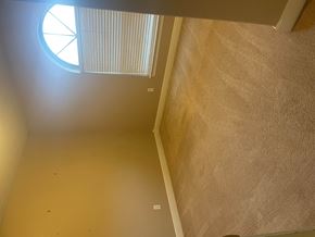 Leesville house for rent - a room with a window and a stairwell and a carpeted floor
