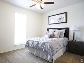 Baton Rouge apartment for rent - a bedroom with a bed and a ceiling fan