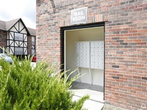 Baton Rouge apartment for rent - the front door of a brick building with a mail room