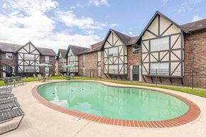 Baton Rouge apartment for rent - a large swimming pool in front of a building