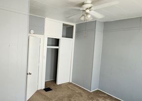Clinton apartment for rent - a room with grey walls and a ceiling fan and a closet