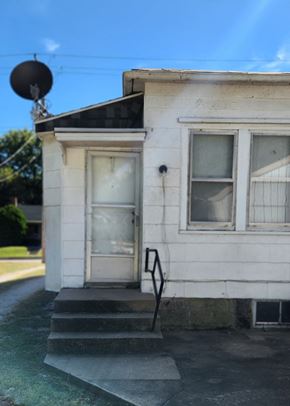 Clinton apartment for rent - a small white building with a door and windows