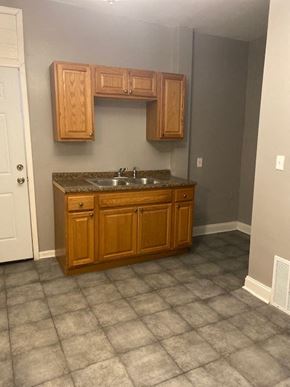 Chicago apartment for rent - a bathroom with a sink and wooden cabinets