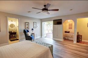 Brandenton house for rent - a bedroom with a large bed and a ceiling fan