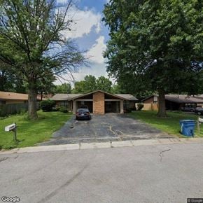 Shiloh apartment for rent - A car is parked in a driveway in front of a house.