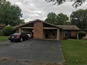 Shiloh apartment for rent - A black car is parked in front of a house.
