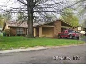 Shiloh apartment for rent - A house with a red car parked in front.