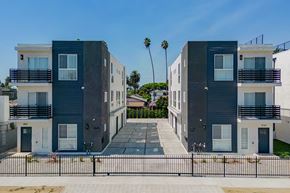 Los Angeles apartment for rent - a row of buildings with palm trees in the background