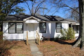 Prentiss house for rent - a white house with a porch and a sidewalk in front of it