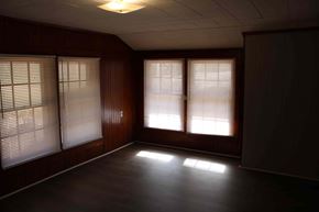 Prentiss house for rent - an empty living room with bay windows