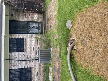 Oak Vale house for rent - an aerial view of a building with a hose in the grass