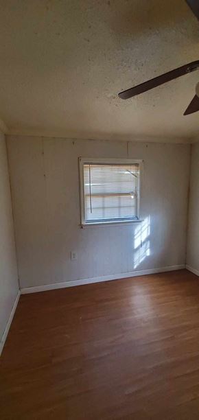 Carson house for rent - an empty room with a window and wooden floors