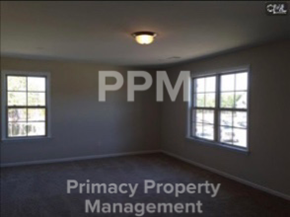 Blythewood house for rent - an empty room with windows and a light on the ceiling