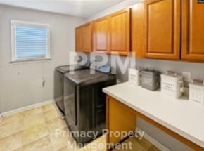 Blythewood house for rent - a kitchen with a dishwasher and wooden cabinets