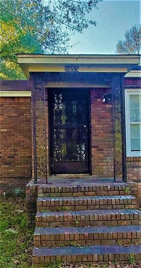 Monticello house for rent - a brick building with a front door and steps