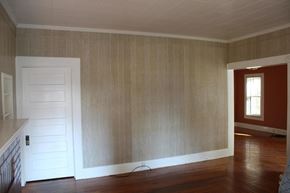 New Hebron house for rent - A room with a white door and wooden walls.