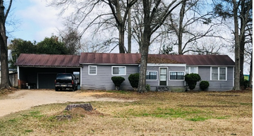 New Hebron house for rent - a house with a rusty roof and a truck parked in front of it