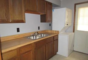 Silver Creek apartment for rent - an empty kitchen with wooden cabinets and a sink