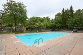 Scarborough apartment for rent - A small pool surrounded by trees and a fence.