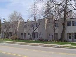 Oakville apartment for rent - Apartment building on a street corner with a yellow line.