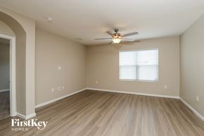 Rockledge house for rent - A spacious room with a ceiling fan and light fixture.