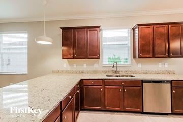 Babcock Ranch house for rent - a kitchen with wooden cabinets and a marble counter top