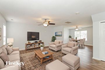 Charlotte house for rent - A living room with a brown coffee table and a white couch.