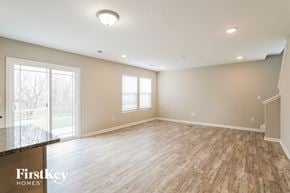 Columbus house for rent - A spacious room with wooden flooring and a large window.