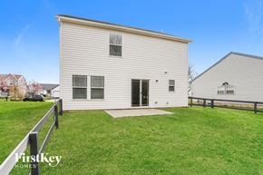 Columbus house for rent - A house with a white exterior and a black car parked in the driveway.