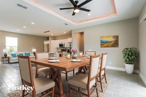 Poinciana house for rent - A dining room with a wooden table and chairs.