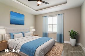 Poinciana house for rent - A bedroom with a bed, two lamps, a ceiling fan, a painting, a window with curtains, and a potted plant.