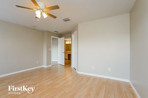 Punta Gorda house for rent - a living room with wood floors and a ceiling fan