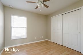 Punta Gorda house for rent - a bedroom with a ceiling fan and a closet