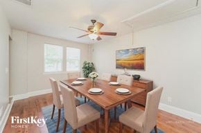 Charlotte house for rent - A dining room with a wooden table and chairs.