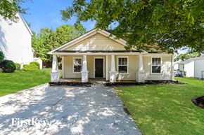Charlotte house for rent - a small white house with a sidewalk in front of it