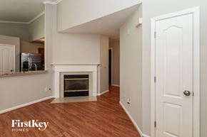 Charlotte house for rent - a living room with a fireplace and a white door